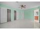 Bedroom with mint green walls, ceiling fan, and tile flooring at 912 Avenue T Se, Winter Haven, FL 33880