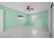 Bedroom with mint green walls, ceiling fan and tile flooring at 912 Avenue T Se, Winter Haven, FL 33880