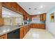Kitchen with wood cabinets, stainless steel appliances, and light blue walls at 912 Avenue T Se, Winter Haven, FL 33880