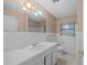 Simple bathroom with white tile, vanity, and tub at 912 Avenue T Se, Winter Haven, FL 33880