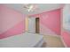 Bedroom with pink walls, ceiling fan and tile flooring at 912 Avenue T Se, Winter Haven, FL 33880