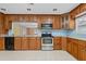 Kitchen with wood cabinets, stainless steel appliances, and light blue walls at 912 Avenue T Se, Winter Haven, FL 33880