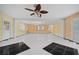 Large living room with tile floors and ceiling fan at 912 Avenue T Se, Winter Haven, FL 33880
