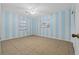 Bedroom with light blue striped walls and tile flooring at 912 Avenue T Se, Winter Haven, FL 33880
