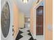 Bright entryway with wood cabinets and black and white tile floor at 912 Avenue T Se, Winter Haven, FL 33880