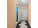 Hallway with peach walls and black and white diamond patterned floor at 912 Avenue T Se, Winter Haven, FL 33880