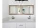 Bathroom with double vanity and large mirrors at 751 Avenue B Sw, Winter Haven, FL 33880