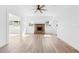 Living room featuring hardwood floors and a brick fireplace at 751 Avenue B Sw, Winter Haven, FL 33880
