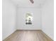 Bright bedroom with wood-look flooring and a large window at 751 Avenue B Sw, Winter Haven, FL 33880