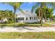 Charming white house with palm trees and sidewalk at 751 Avenue B Sw, Winter Haven, FL 33880