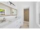 Double vanity bathroom with quartz countertops and walk-in shower at 751 Avenue B Sw, Winter Haven, FL 33880