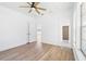 Spacious bedroom with wood-look floors and access to bathroom at 751 Avenue B Sw, Winter Haven, FL 33880