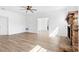 Living room with hardwood floors, fireplace, and ceiling fan at 751 Avenue B Sw, Winter Haven, FL 33880