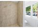 Shower and toilet in a small bathroom with white brick at 751 Avenue B Sw, Winter Haven, FL 33880