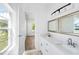 Bright bathroom with double vanity, large mirrors, and a separate tub at 751 Avenue B Sw, Winter Haven, FL 33880