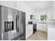 Modern kitchen with white cabinets, stainless steel appliances, and quartz countertops at 751 Avenue B Sw, Winter Haven, FL 33880