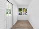 Bright sunroom with white brick walls, wood-look flooring, and large windows at 751 Avenue B Sw, Winter Haven, FL 33880