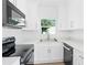 Modern kitchen with white shaker cabinets and stainless steel appliances at 751 Avenue B Sw, Winter Haven, FL 33880