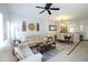 Open living room and dining area with light beige couch and table at 4734 Vero Beach Pl, Kissimmee, FL 34746