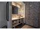 Modern bathroom with a white sink, brick-look wall, and open shelving at 5245 W Irlo Bronson Memorial Hwy # 160, Kissimmee, FL 34746