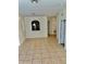 Open living room with tile floors and a kitchen peek at 6265 Contessa Dr # 101, Orlando, FL 32829