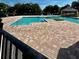 Community pool area with surrounding patio and seating at 6265 Contessa Dr # 101, Orlando, FL 32829