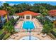 Community pool and splash pad with lounge chairs, surrounded by buildings at 1049 Lake Berkley Dr, Kissimmee, FL 34746