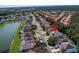 Aerial view showing home's location in a residential neighborhood with a lake nearby at 1049 Lake Berkley Dr, Kissimmee, FL 34746