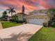 Stunning curb appeal with a two-car garage and mature landscaping at 1049 Lake Berkley Dr, Kissimmee, FL 34746
