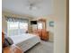 Cozy bedroom with a dresser and a comfortable bed at 1049 Lake Berkley Dr, Kissimmee, FL 34746