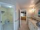Main bathroom with double vanity and access to walk-in closet and bedroom at 1049 Lake Berkley Dr, Kissimmee, FL 34746