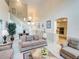 Spacious living room with high ceilings and views into kitchen area at 1049 Lake Berkley Dr, Kissimmee, FL 34746