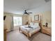 Bedroom with a queen bed and ceiling fan at 1049 Lake Berkley Dr, Kissimmee, FL 34746