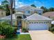 Beautiful two-story home with a two-car garage and well-manicured lawn at 1049 Lake Berkley Dr, Kissimmee, FL 34746