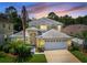 Two-story home with three-car garage and lush landscaping at 1049 Lake Berkley Dr, Kissimmee, FL 34746