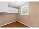 Small office space with built-in shelving and wood-look flooring at 7819 Puritan Rd, Orlando, FL 32807