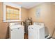 Laundry room with washer, dryer, and water heater at 7819 Puritan Rd, Orlando, FL 32807