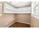 Bright office featuring corner shelving and wood-look tile floor at 7819 Puritan Rd, Orlando, FL 32807