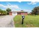 Brick home with a large yard, driveway, and mailbox at 7819 Puritan Rd, Orlando, FL 32807