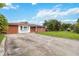 Brick home with a large yard and driveway at 7819 Puritan Rd, Orlando, FL 32807