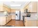 Galley kitchen with stainless steel appliances and wood floors at 7819 Puritan Rd, Orlando, FL 32807