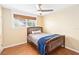 Cozy bedroom featuring wood floors and a full-size bed at 7819 Puritan Rd, Orlando, FL 32807