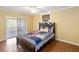 Bedroom with wood-look tile floor and sliding glass doors at 7819 Puritan Rd, Orlando, FL 32807