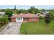 Brick ranch house with a driveway and large lawn at 7819 Puritan Rd, Orlando, FL 32807