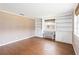 Living room with tile floors, built-in shelving, and large window at 7819 Puritan Rd, Orlando, FL 32807
