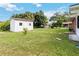 Large backyard with shed, grassy lawn, and stepping stones at 7819 Puritan Rd, Orlando, FL 32807