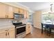 Kitchen with stainless steel appliances and light wood cabinets at 7819 Puritan Rd, Orlando, FL 32807