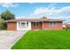Brick home with a large yard and driveway at 7819 Puritan Rd, Orlando, FL 32807