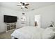 Main bedroom with king bed, TV stand, and view of additional sitting area at 1294 Harbor Ridge Dr, Kissimmee, FL 34759