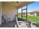 Screened patio with brick floor, and views of a grassy backyard and neighboring houses at 1294 Harbor Ridge Dr, Kissimmee, FL 34759